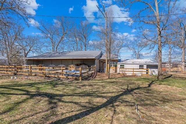 back of house featuring a wooden deck, a lawn, and fence