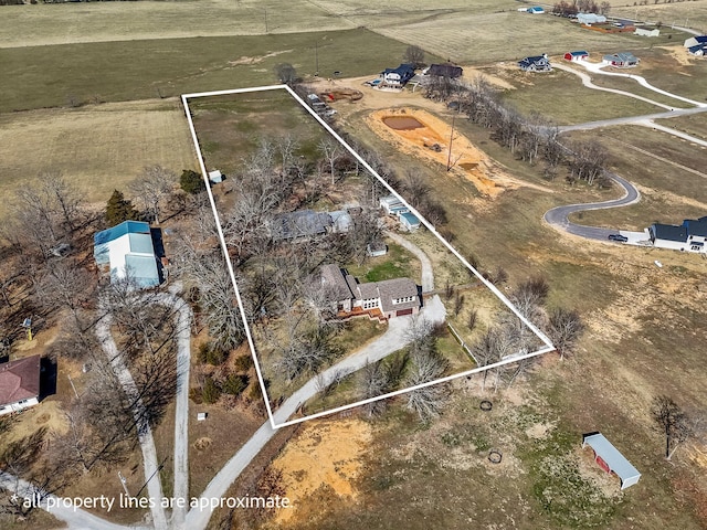 birds eye view of property with a rural view