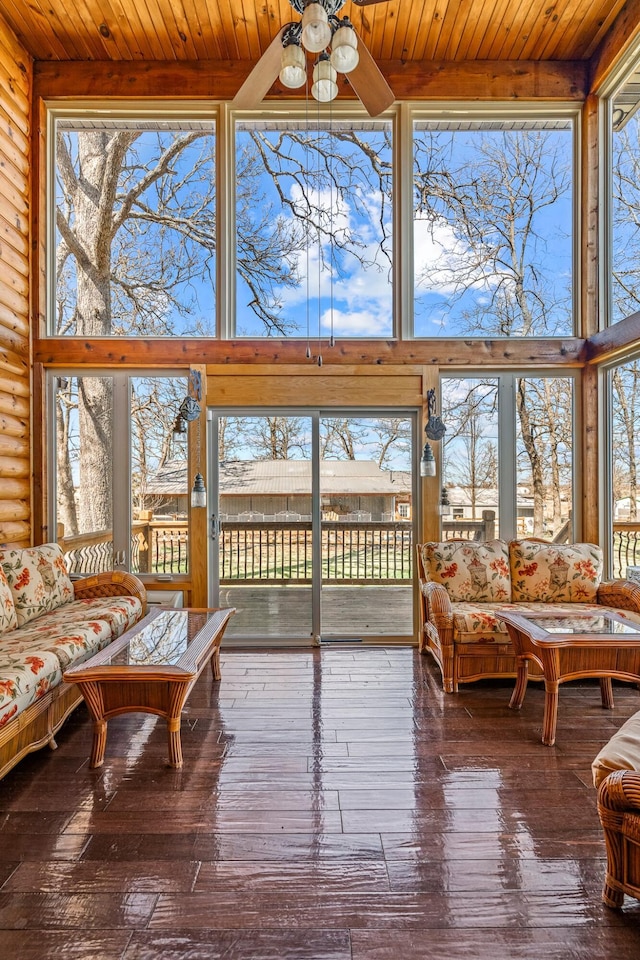 sunroom / solarium with wooden ceiling and a ceiling fan