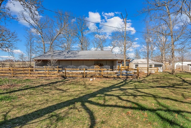 rear view of property with an outdoor structure