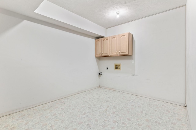 washroom featuring a textured ceiling, hookup for a washing machine, cabinet space, and electric dryer hookup