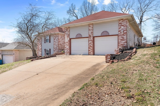 view of front of house with concrete driveway, a garage, and brick siding