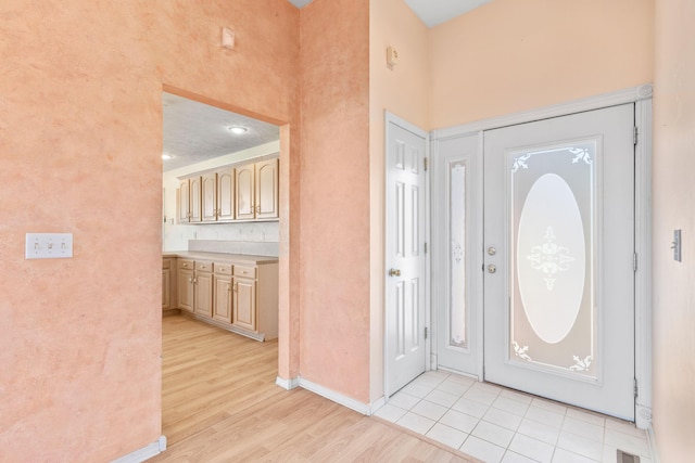 entryway with visible vents, baseboards, and light wood-type flooring