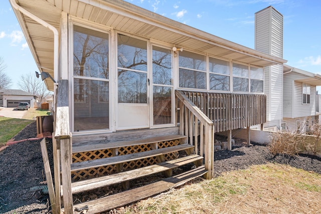 exterior space featuring a sunroom and a chimney