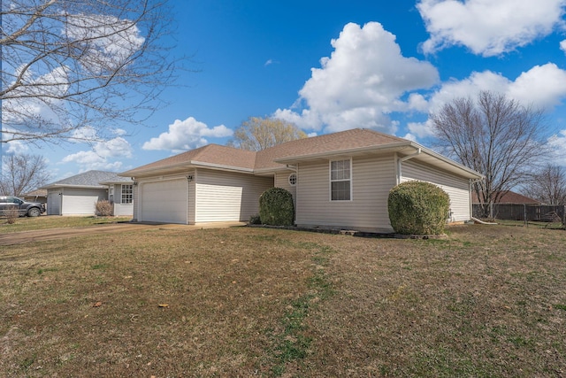 ranch-style house featuring an attached garage, driveway, a front lawn, and fence