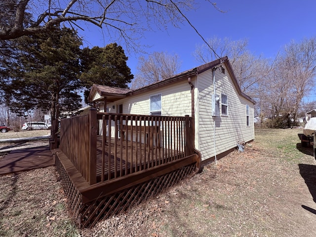 view of property exterior with a wooden deck