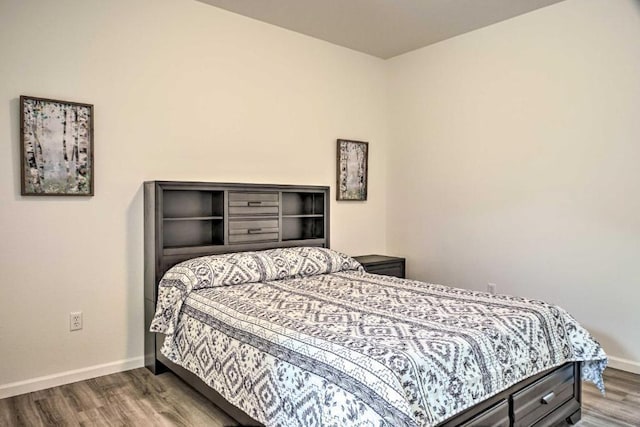 bedroom featuring baseboards and wood finished floors