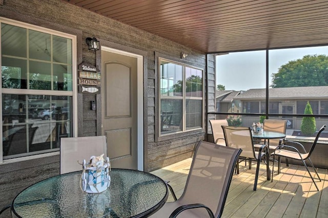 sunroom with a healthy amount of sunlight and wood ceiling