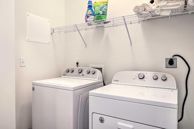 clothes washing area featuring independent washer and dryer and laundry area