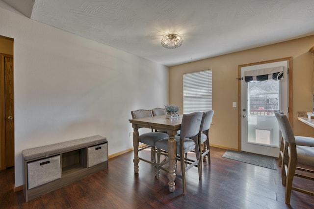 dining room with dark wood finished floors and baseboards