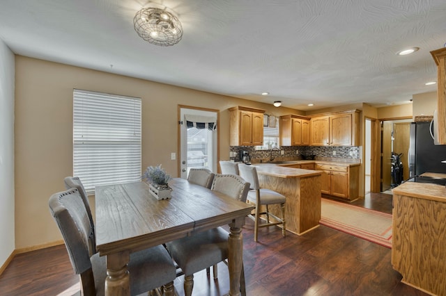 dining area with recessed lighting, baseboards, and dark wood-style floors