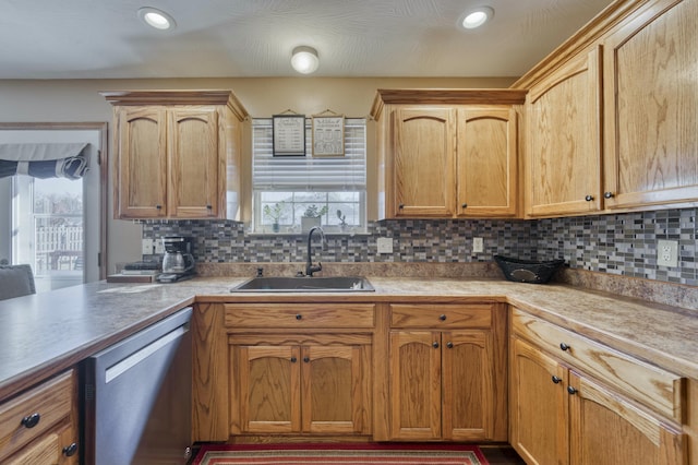 kitchen with tasteful backsplash, light countertops, recessed lighting, stainless steel dishwasher, and a sink