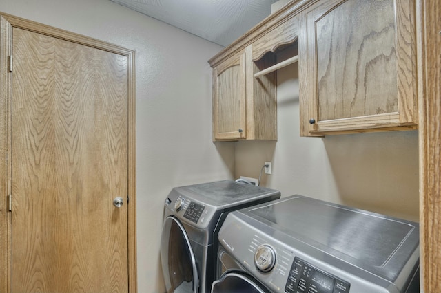 laundry area featuring washer and dryer and cabinet space