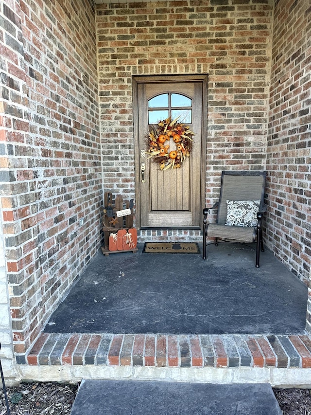 property entrance featuring brick siding