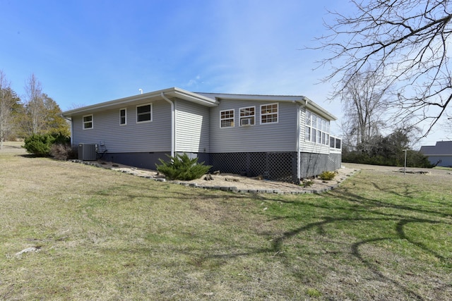 exterior space with central air condition unit and a yard