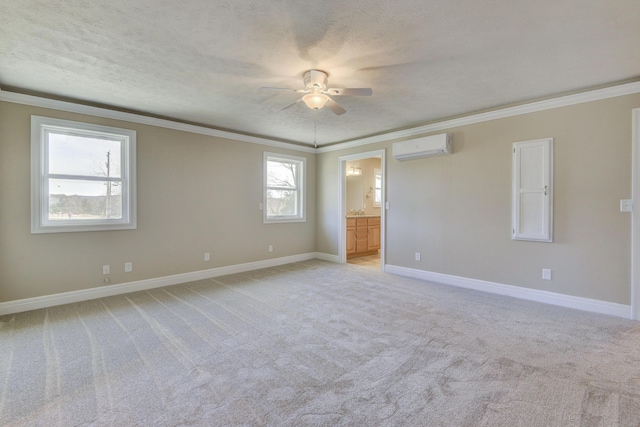 empty room featuring crown molding, an AC wall unit, and light colored carpet