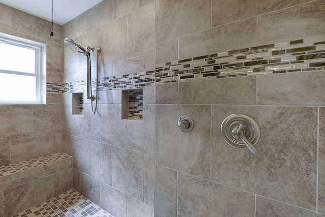 full bathroom with tiled shower