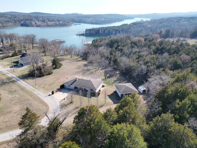 aerial view featuring a forest view and a water view