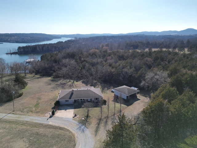 aerial view featuring a wooded view and a water view