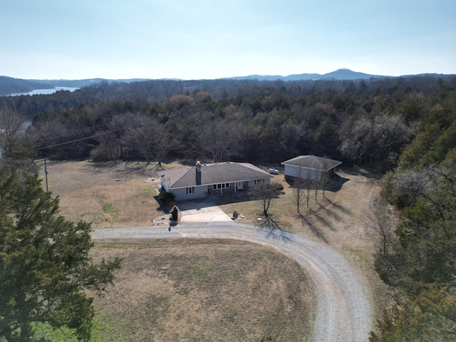 drone / aerial view featuring a forest view