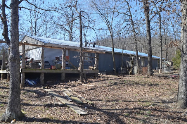 exterior space featuring metal roof and a deck