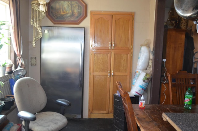 kitchen with tile countertops and stainless steel refrigerator