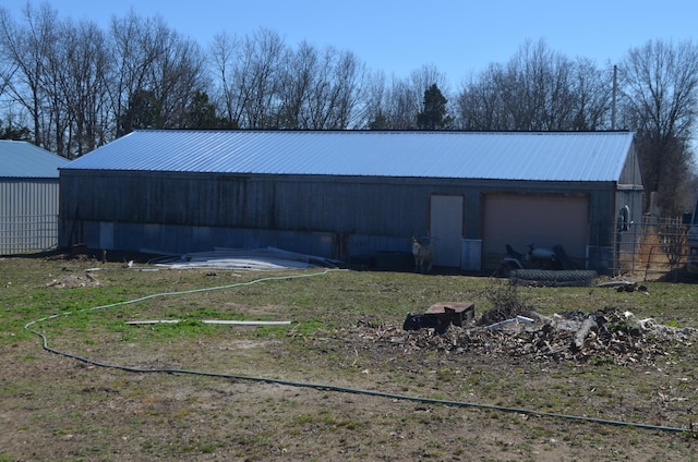 view of pole building featuring fence