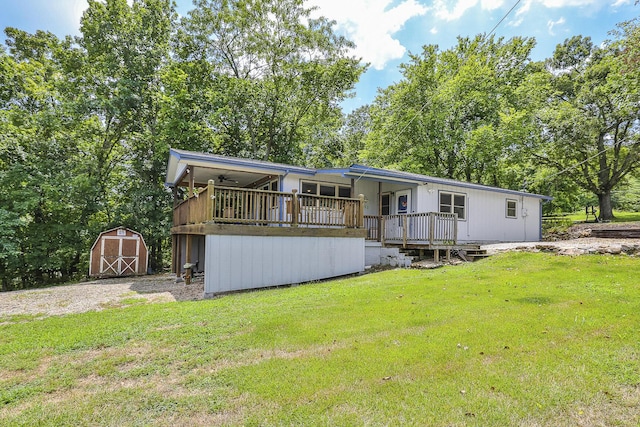 manufactured / mobile home with a storage unit, an outdoor structure, and a front yard