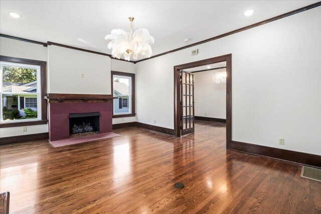 unfurnished living room with a wealth of natural light, a fireplace, and wood finished floors