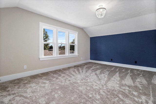 bonus room with lofted ceiling, baseboards, and carpet floors