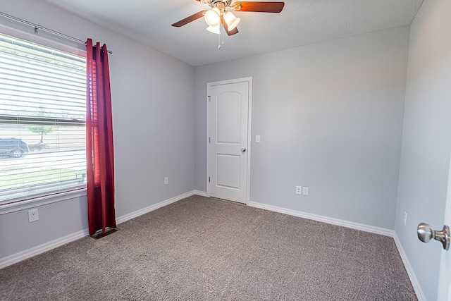 unfurnished room featuring baseboards, carpet floors, a healthy amount of sunlight, and a ceiling fan