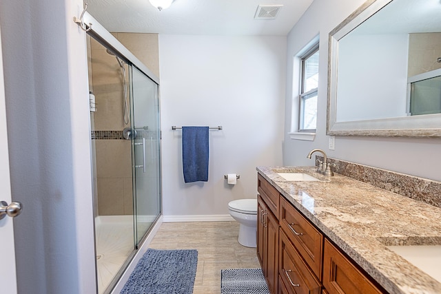 full bath with a sink, visible vents, and a shower stall