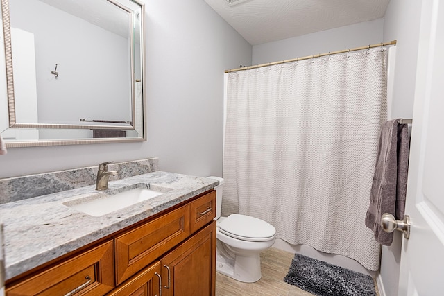 bathroom with toilet, wood finished floors, and vanity