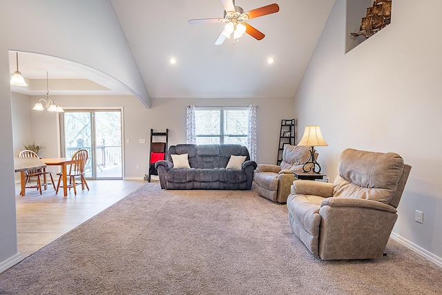 living room with a towering ceiling, light colored carpet, and a wealth of natural light