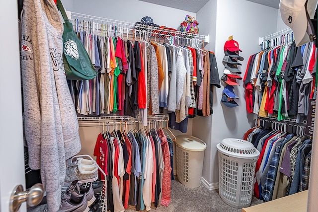 walk in closet featuring carpet flooring