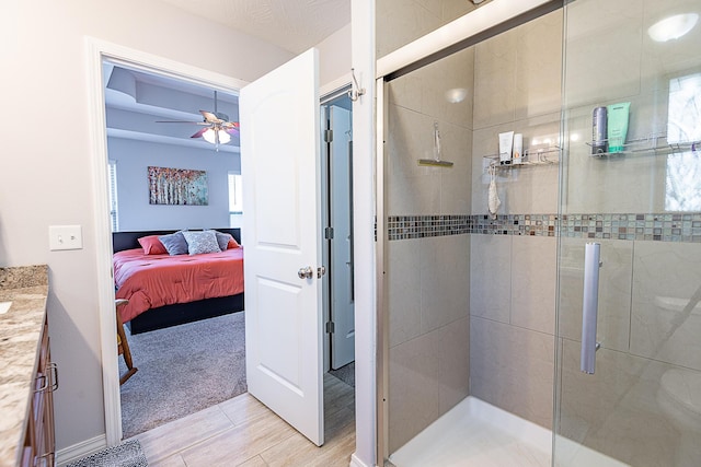 bathroom featuring vanity, a ceiling fan, a stall shower, and connected bathroom