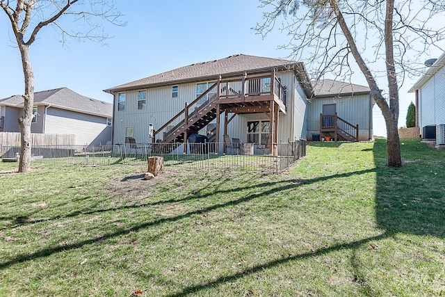 back of house featuring central AC unit, fence, a wooden deck, stairs, and a lawn