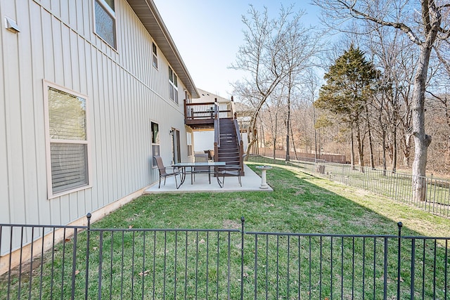 view of yard featuring stairway, a patio, a wooden deck, and a fenced backyard