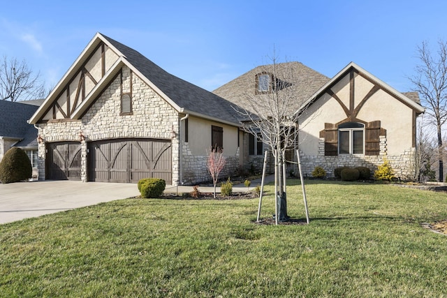 tudor-style house featuring stucco siding, concrete driveway, a front lawn, a garage, and stone siding