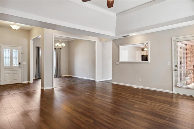 unfurnished living room with visible vents, baseboards, wood finished floors, and ceiling fan with notable chandelier