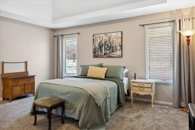 bedroom with baseboards and light carpet