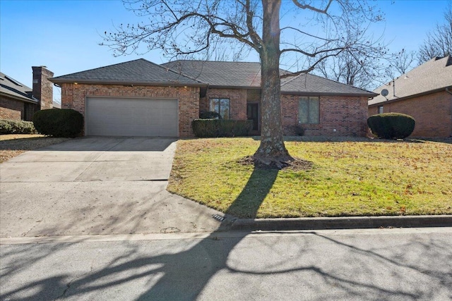 ranch-style house with concrete driveway, brick siding, a garage, and a front lawn