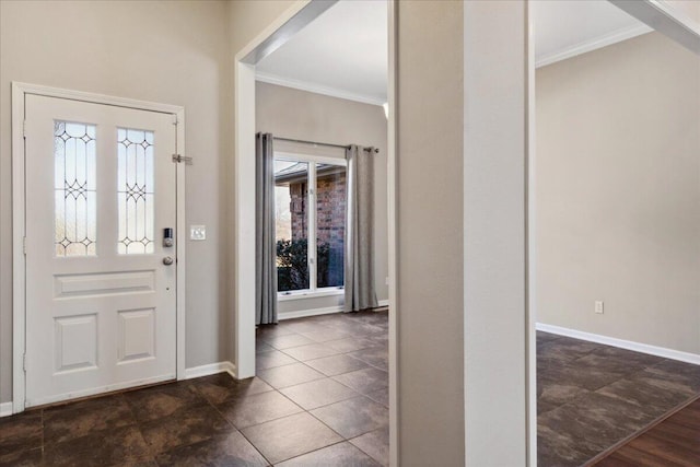 entrance foyer featuring baseboards and ornamental molding