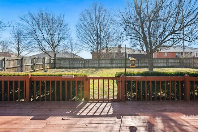 deck featuring a fenced backyard and a lawn