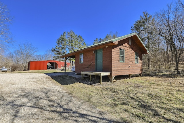 view of side of home with an outdoor structure and a pole building