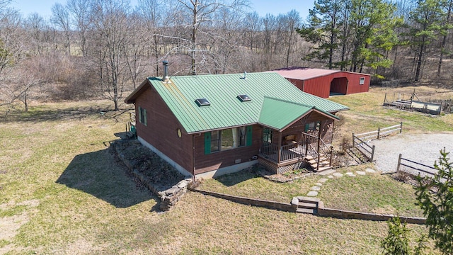 exterior space featuring a front yard, an outbuilding, and fence