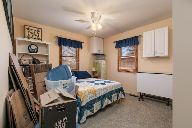 carpeted bedroom with baseboards and ceiling fan