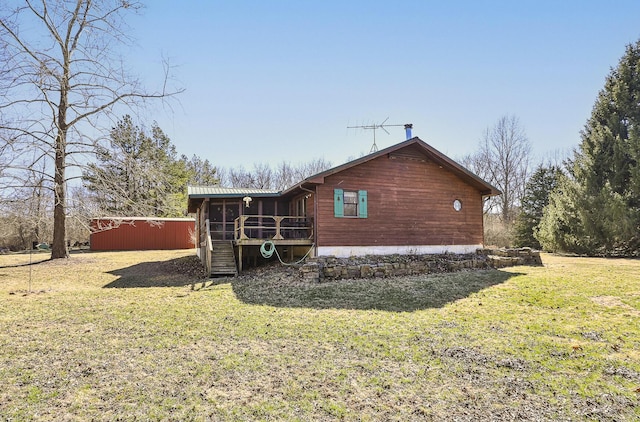 rear view of property featuring a yard