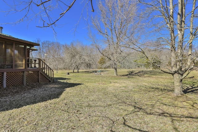 view of yard with stairway and a sunroom