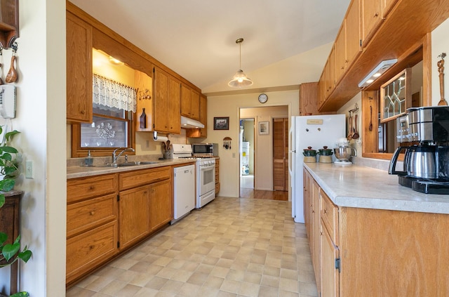 kitchen featuring under cabinet range hood, light countertops, lofted ceiling, white appliances, and a sink